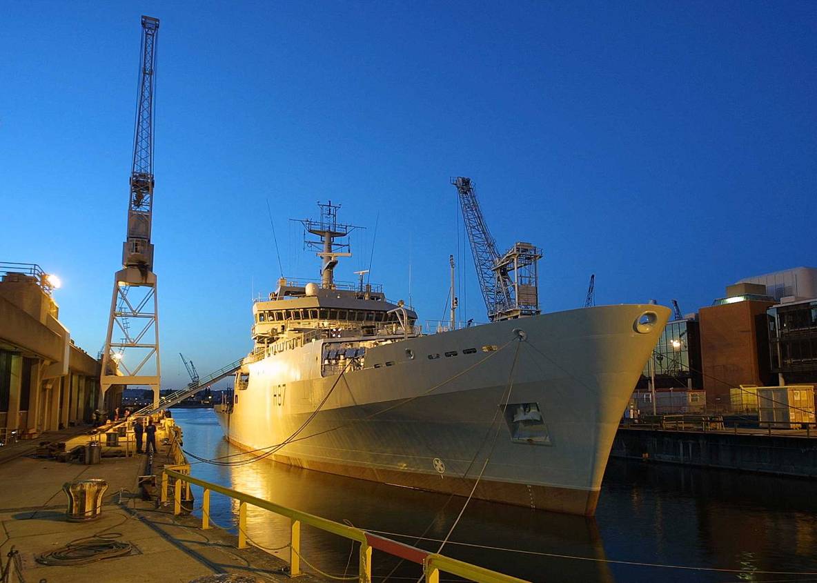 image of HMS Echo in port, floodlit at night